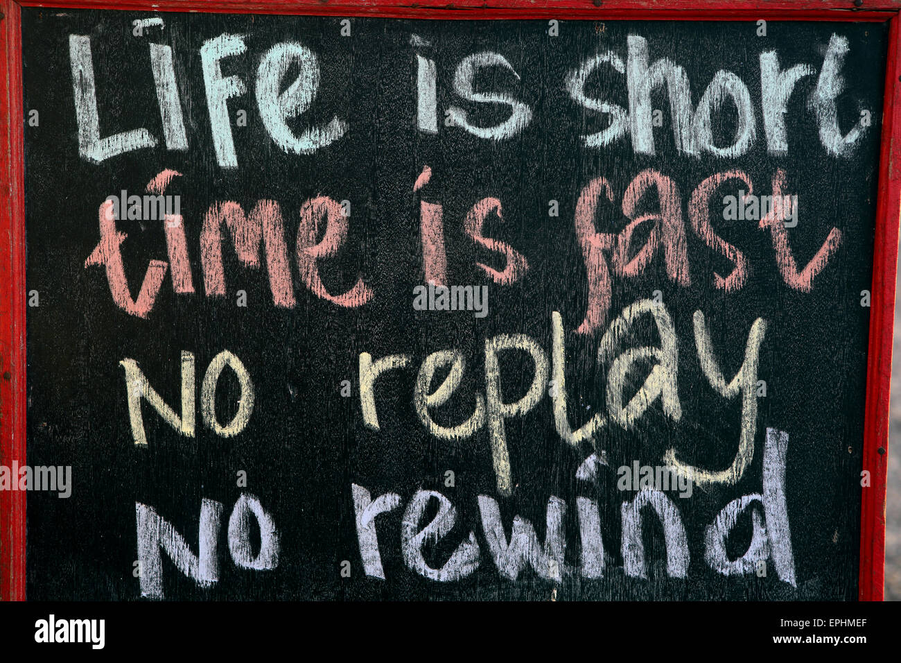 Blackboard sign with message life is short, time is fast, no replay