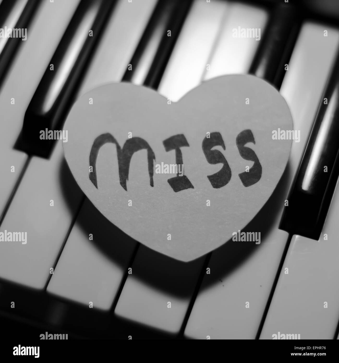 paper heart on piano keyboard black and white color Stock Photo Alamy