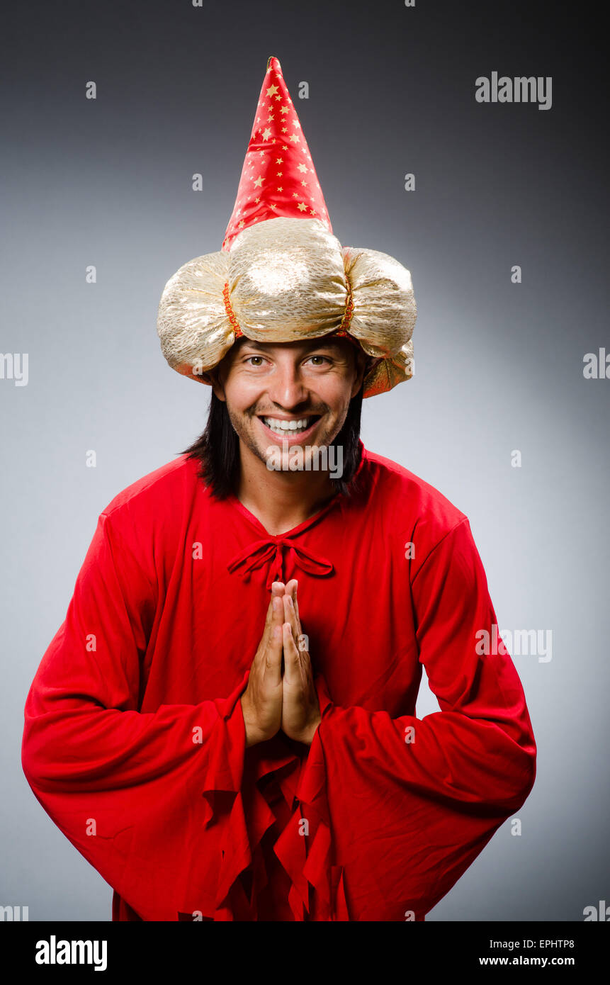 Funny wizard wearing red dress Stock Photo - Alamy