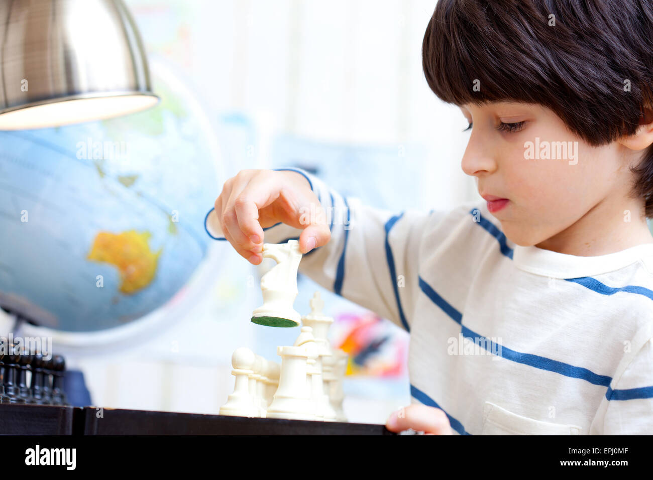 boy playing a game of chess Stock Photo