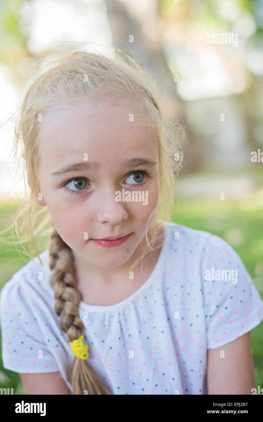 Beautiful little girl with big eyes outdoors Stock Photo