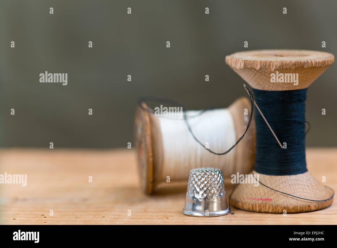 two spools of thread with thimble Stock Photo Alamy