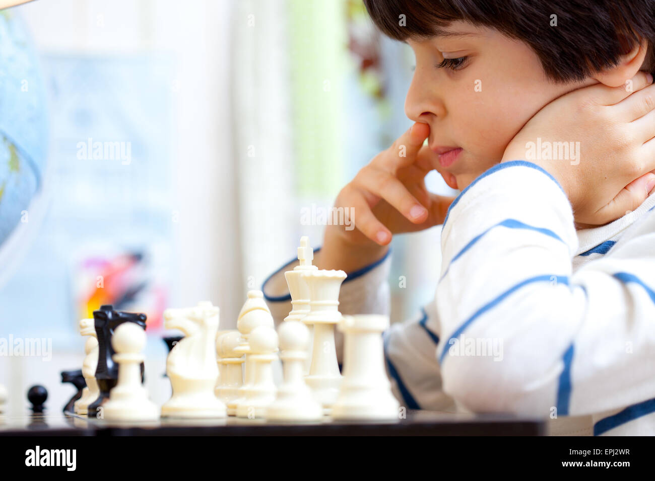boy playing a game of chess Stock Photo