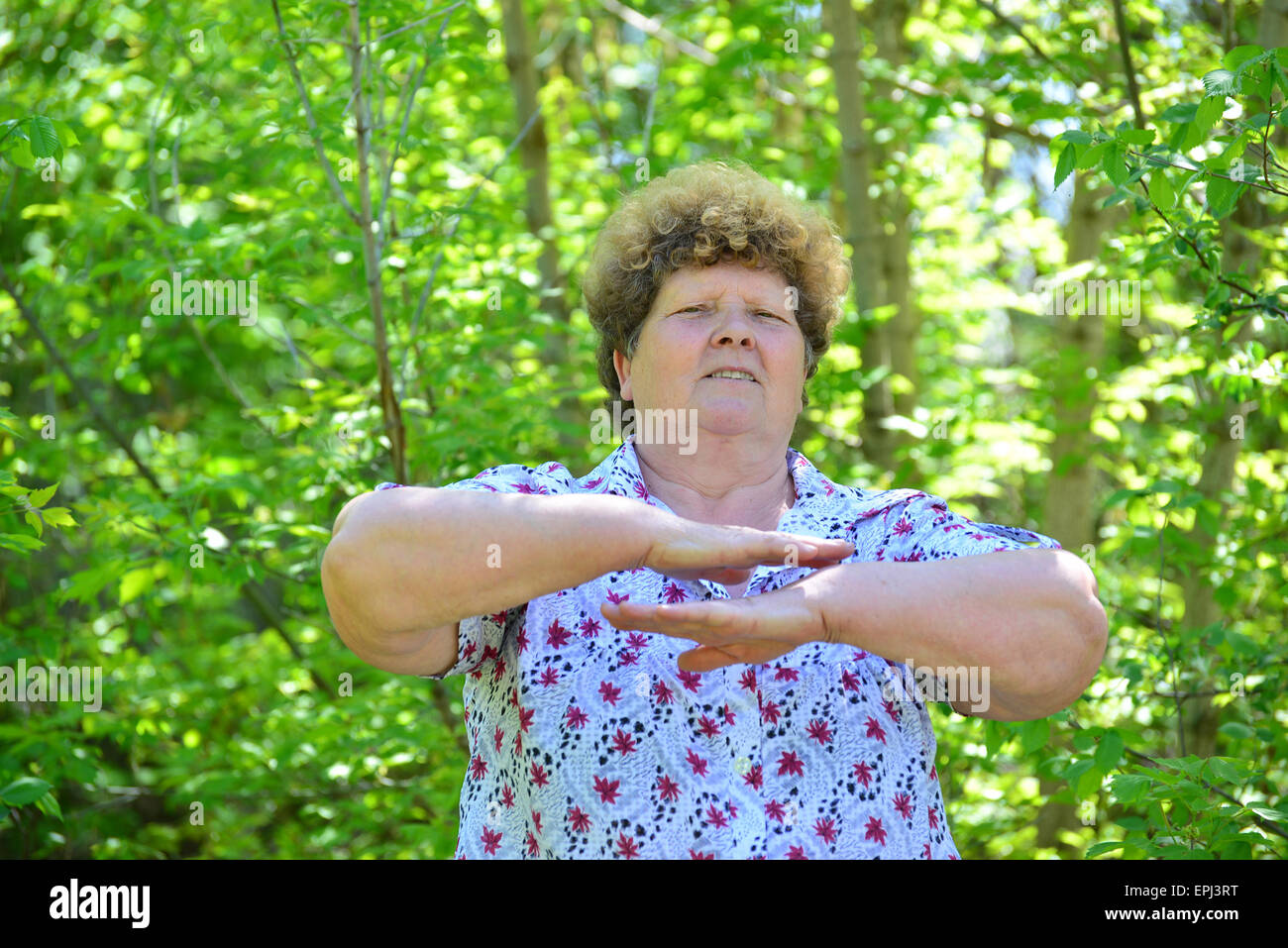 Mature woman doing exercises in a nature Stock Photo