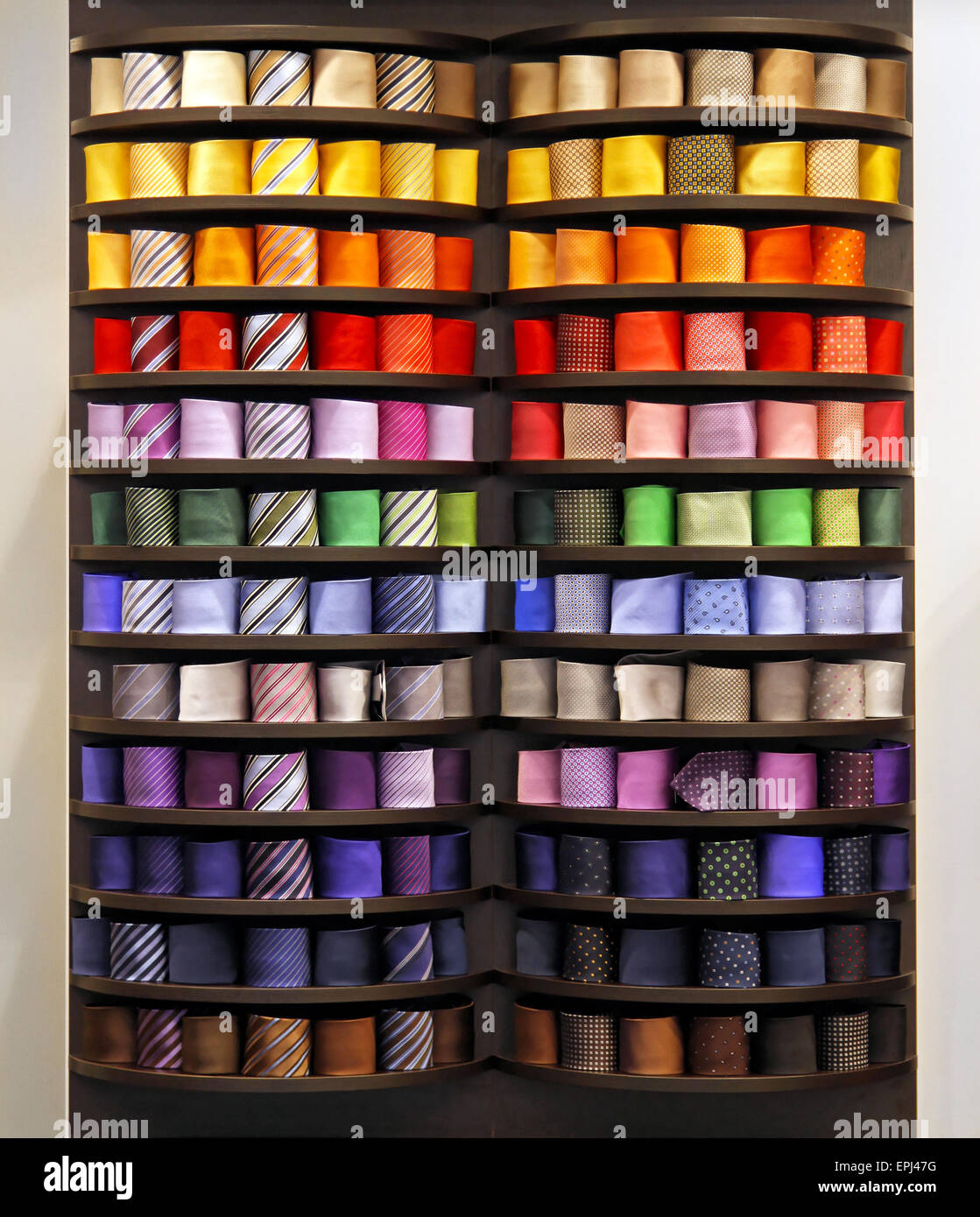 Big collection of colourful ties in rack Stock Photo