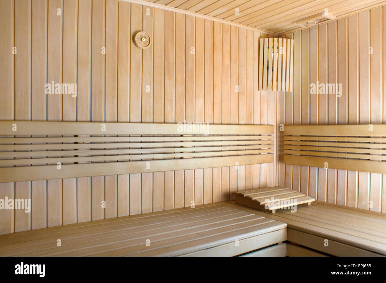 Round thermometer on the wall of traditional wooden sauna Stock Photo
