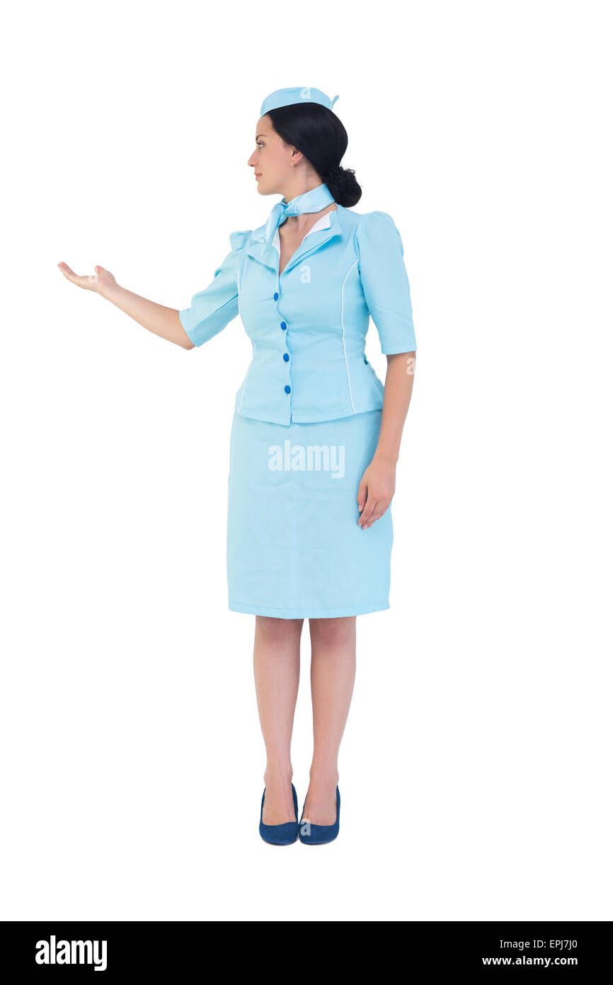 Pretty air hostess showing with hand Stock Photo