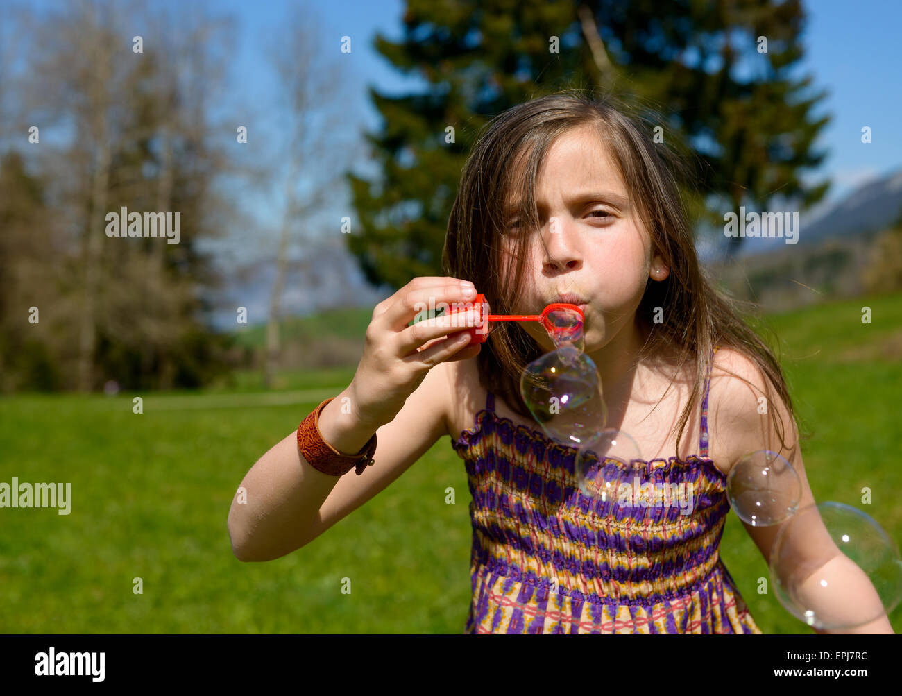 a little girl making soap bubbles in nature Stock Photo - Alamy