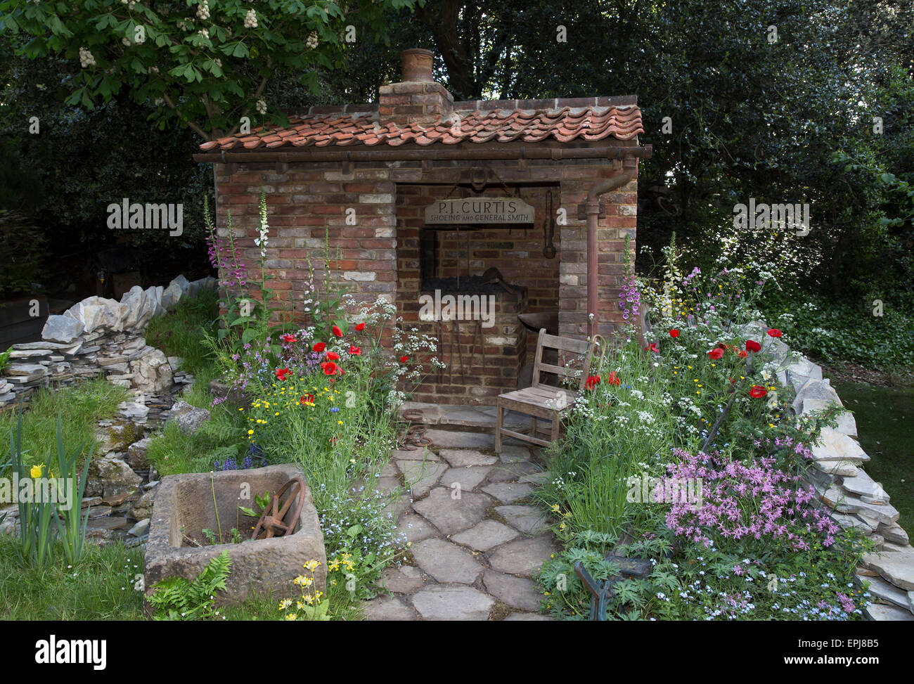 Chelsea, London, UK. 19th May, 2015. The old forge garden for motor neurone disease association at Chelsea Flower Show 2015. Credit:  Keith Larby/Alamy Live News Stock Photo