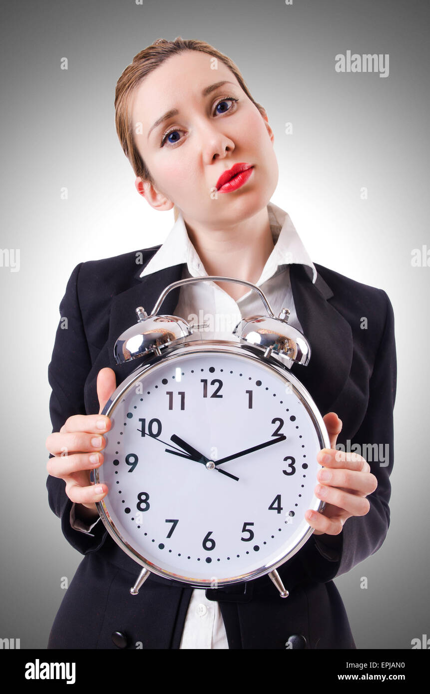 Woman businesswoman with giant clock Stock Photo - Alamy