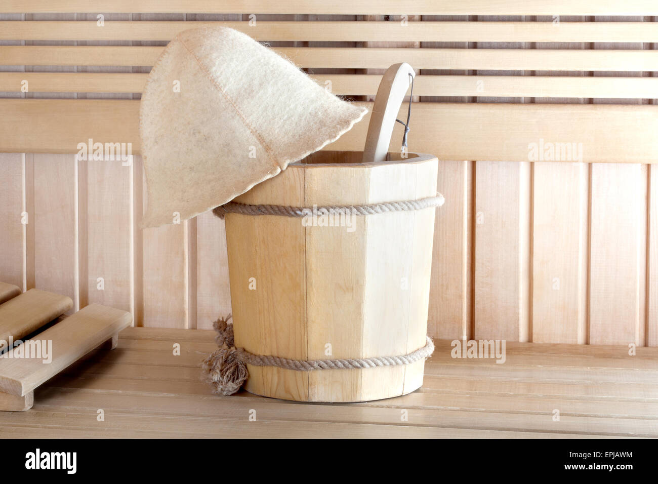 Traditional wooden sauna for relaxation with bucket of water Stock Photo