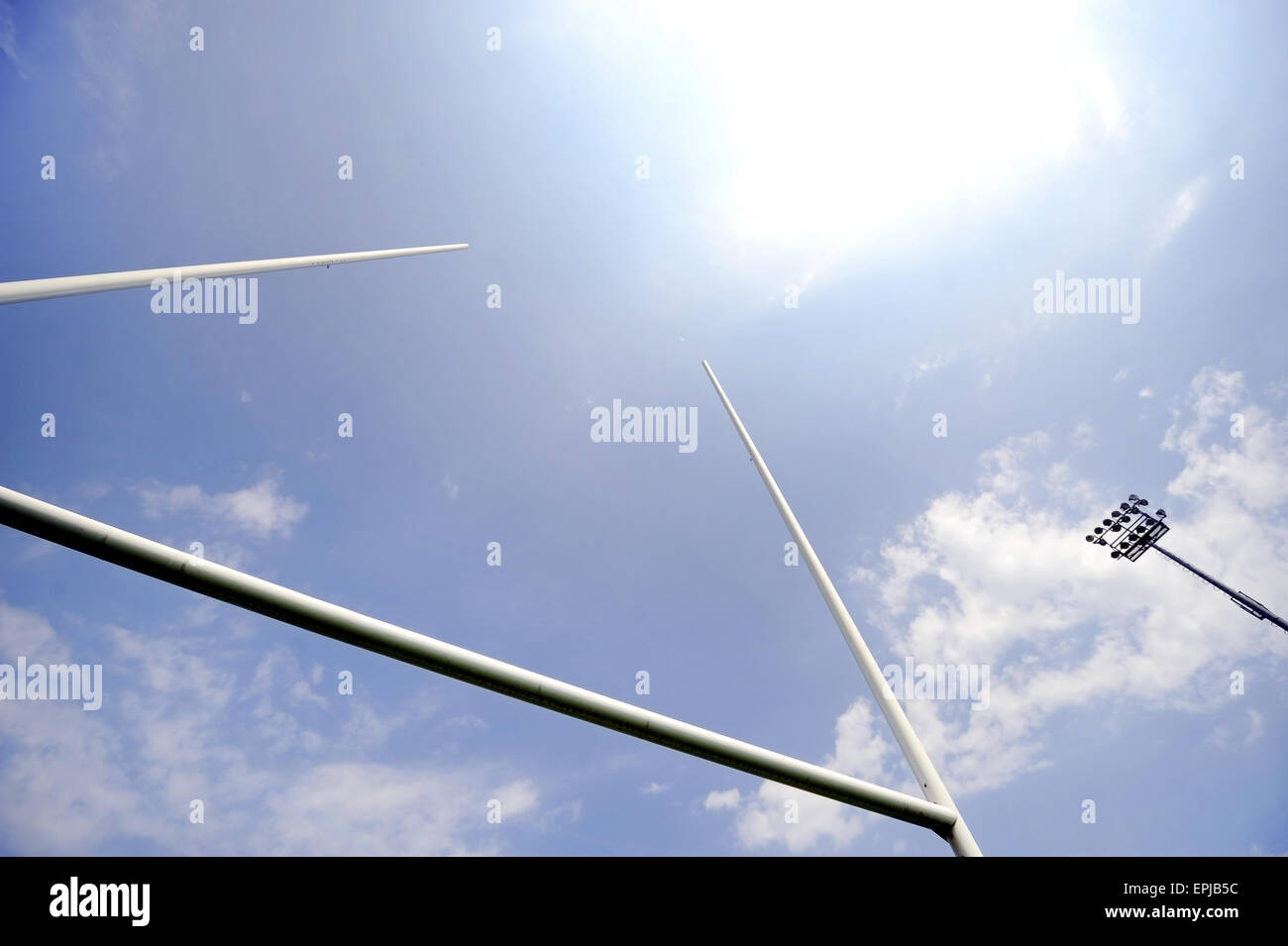 Rugby goal posts with stadium spotlights and blue sky on the background Stock Photo