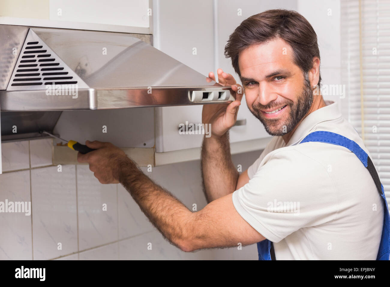 Handyman fixing the oven Stock Photo Alamy