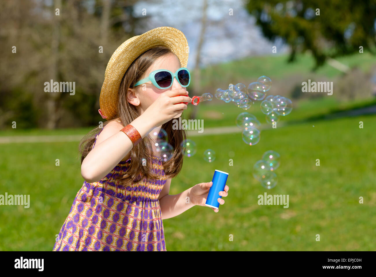 a little girl with sunglasses making soap bubbles Stock Photo - Alamy