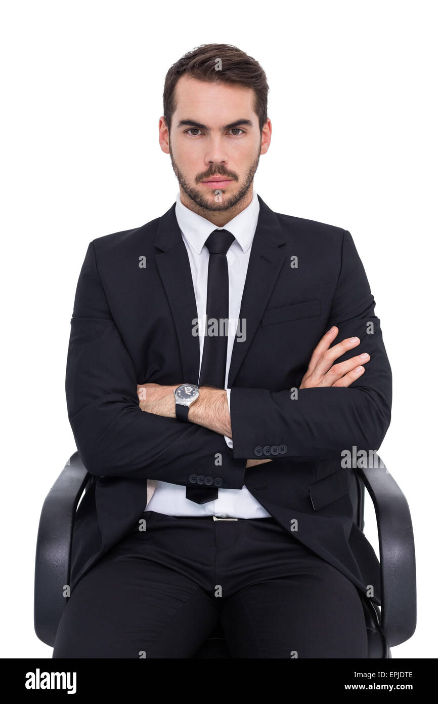 Serious businessman sitting with arms crossed Stock Photo - Alamy