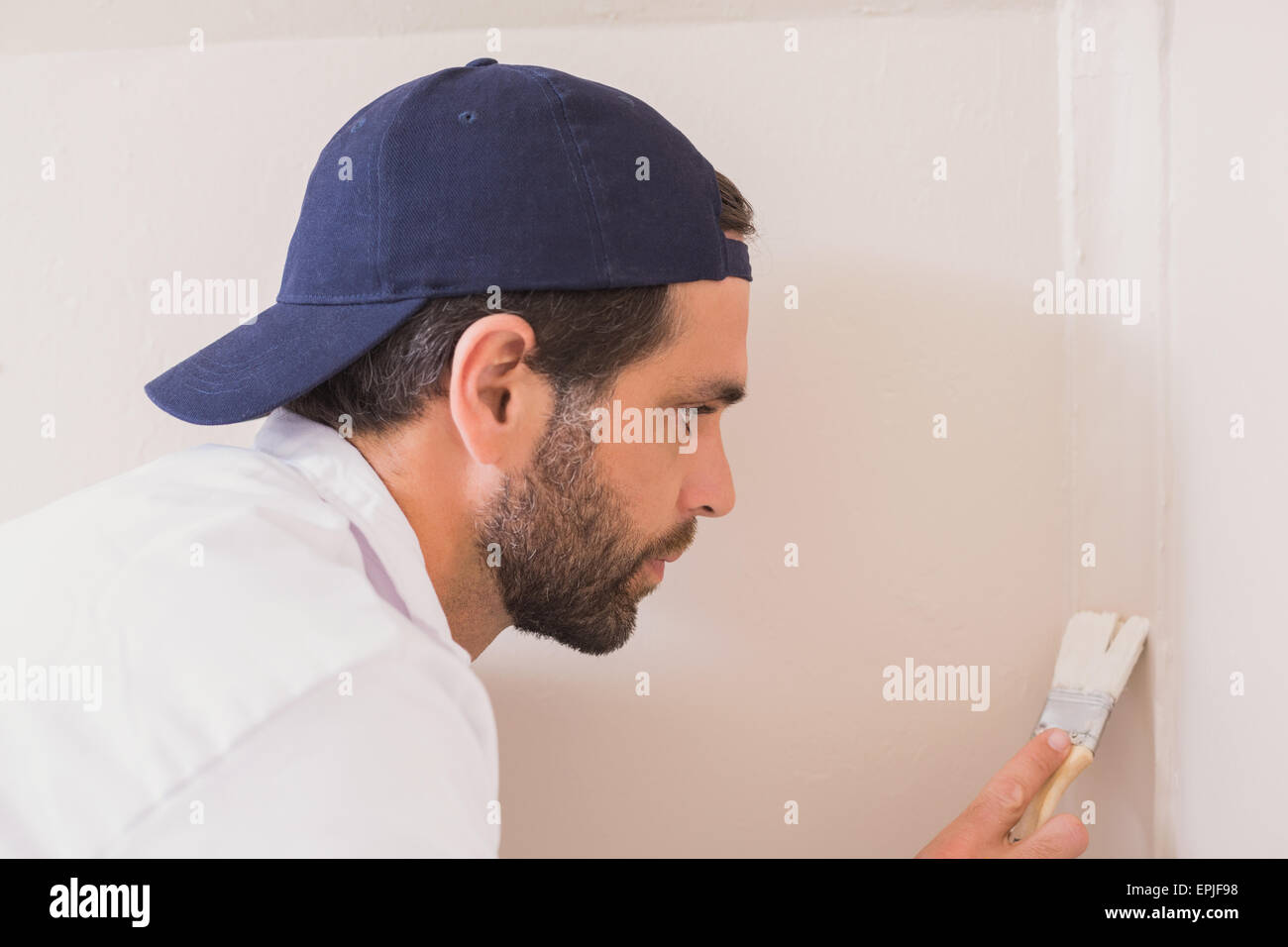 Painter painting the walls white Stock Photo Alamy