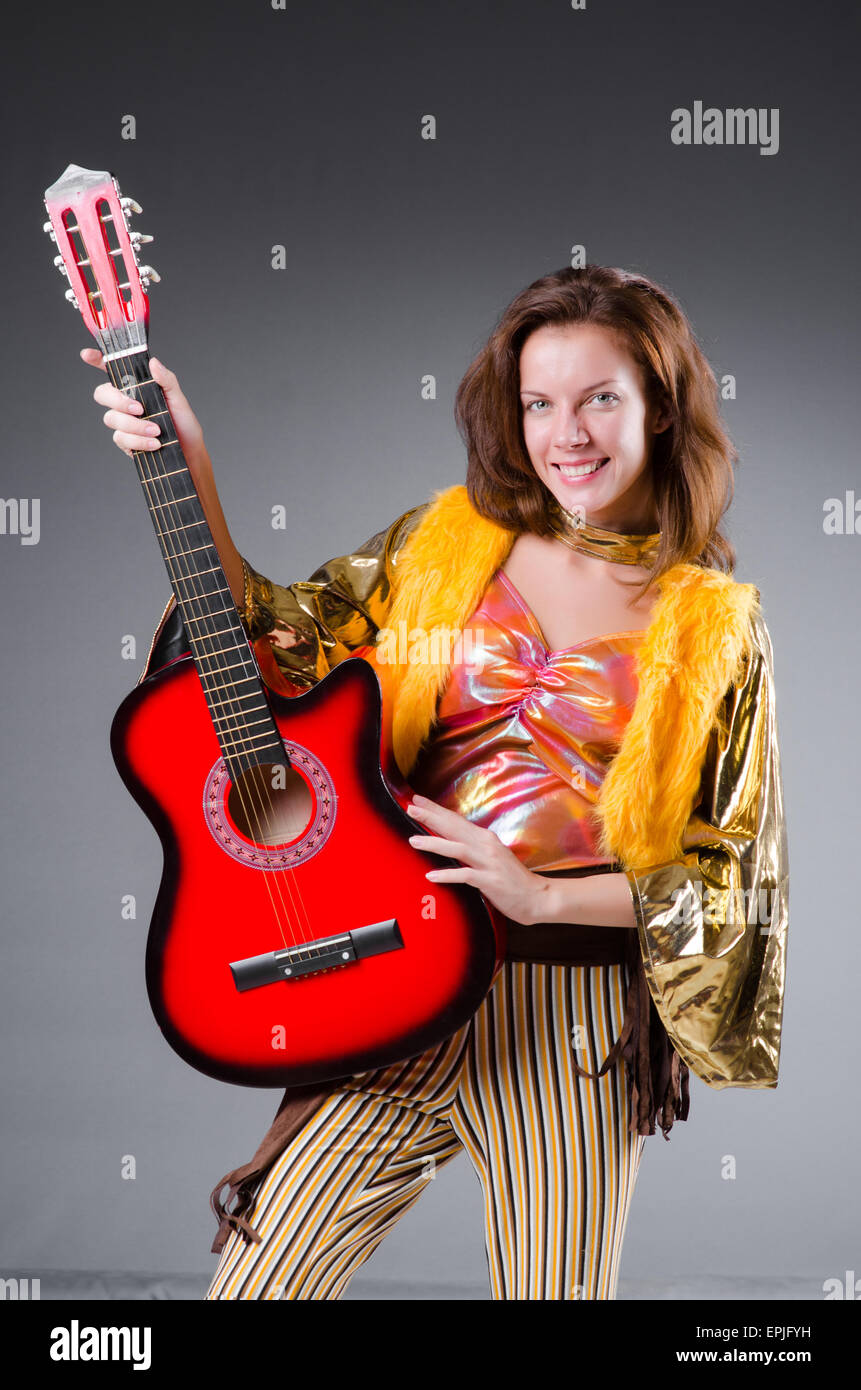 Guitar player with red instrument Stock Photo - Alamy