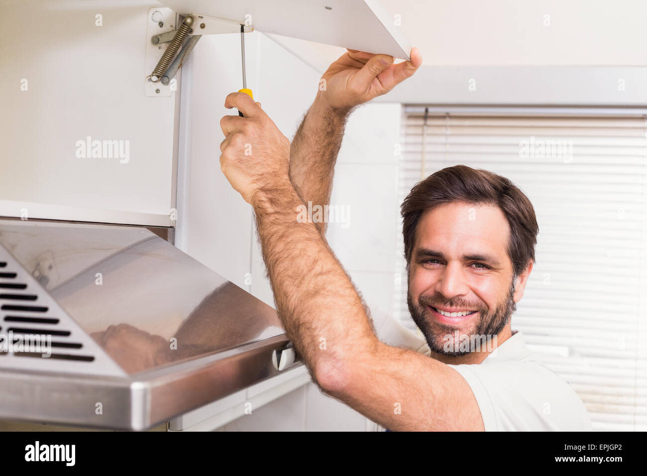 Handyman putting up a shelf Stock Photo Alamy