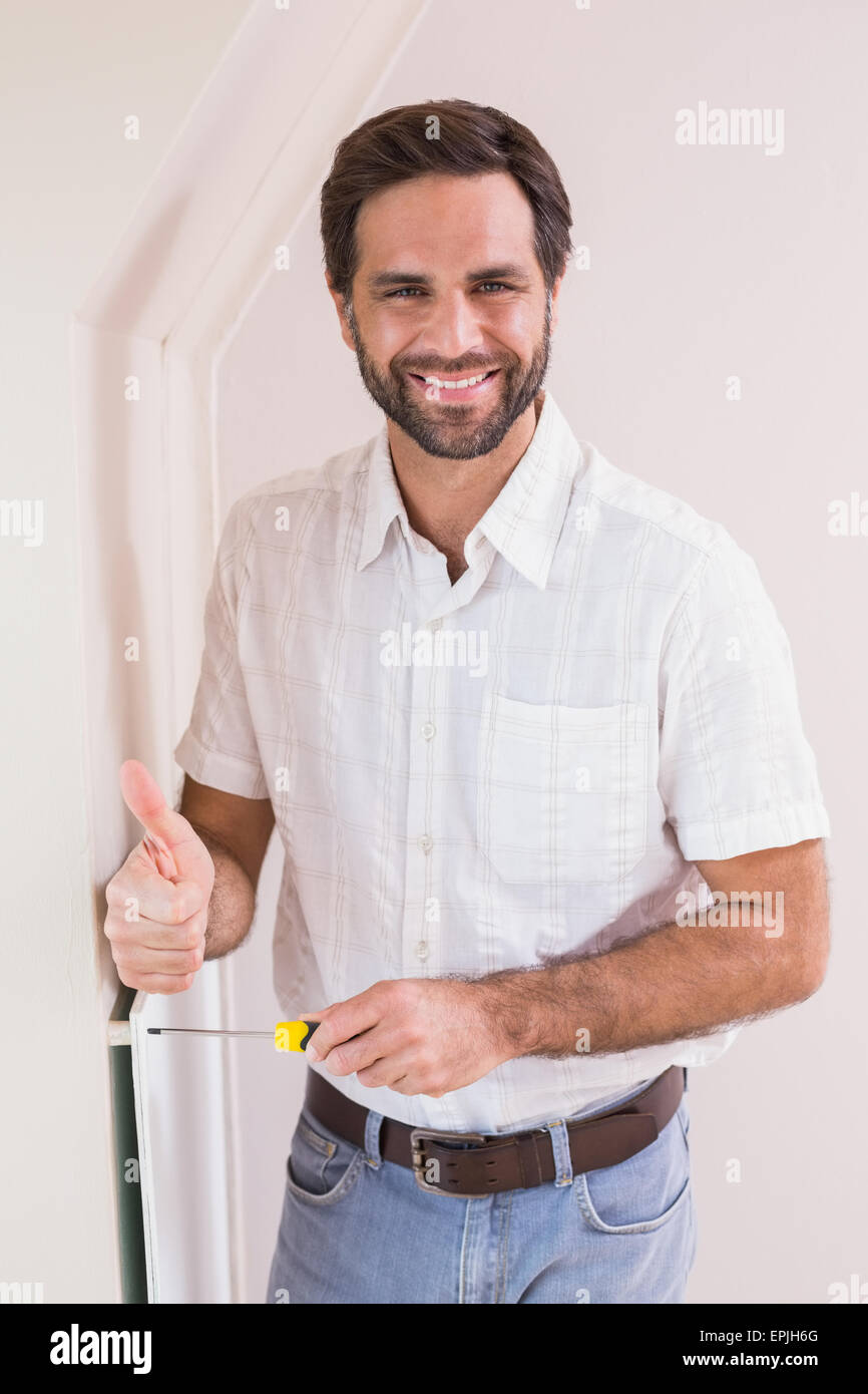 Handyman hanging up a radiator Stock Photo Alamy