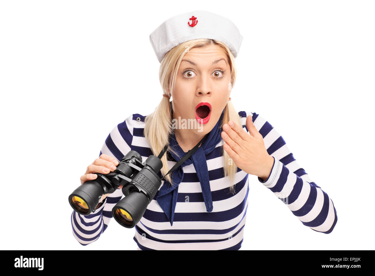 Surprised female sailor holding binoculars and looking at the camera ...
