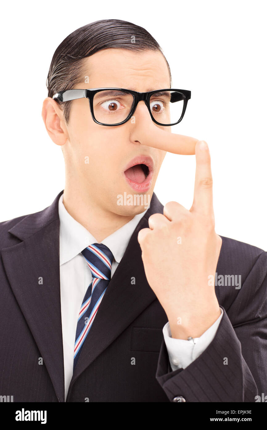 Vertical shot of a young displeased businessman looking at his long nose and trying to put it back with his finger Stock Photo