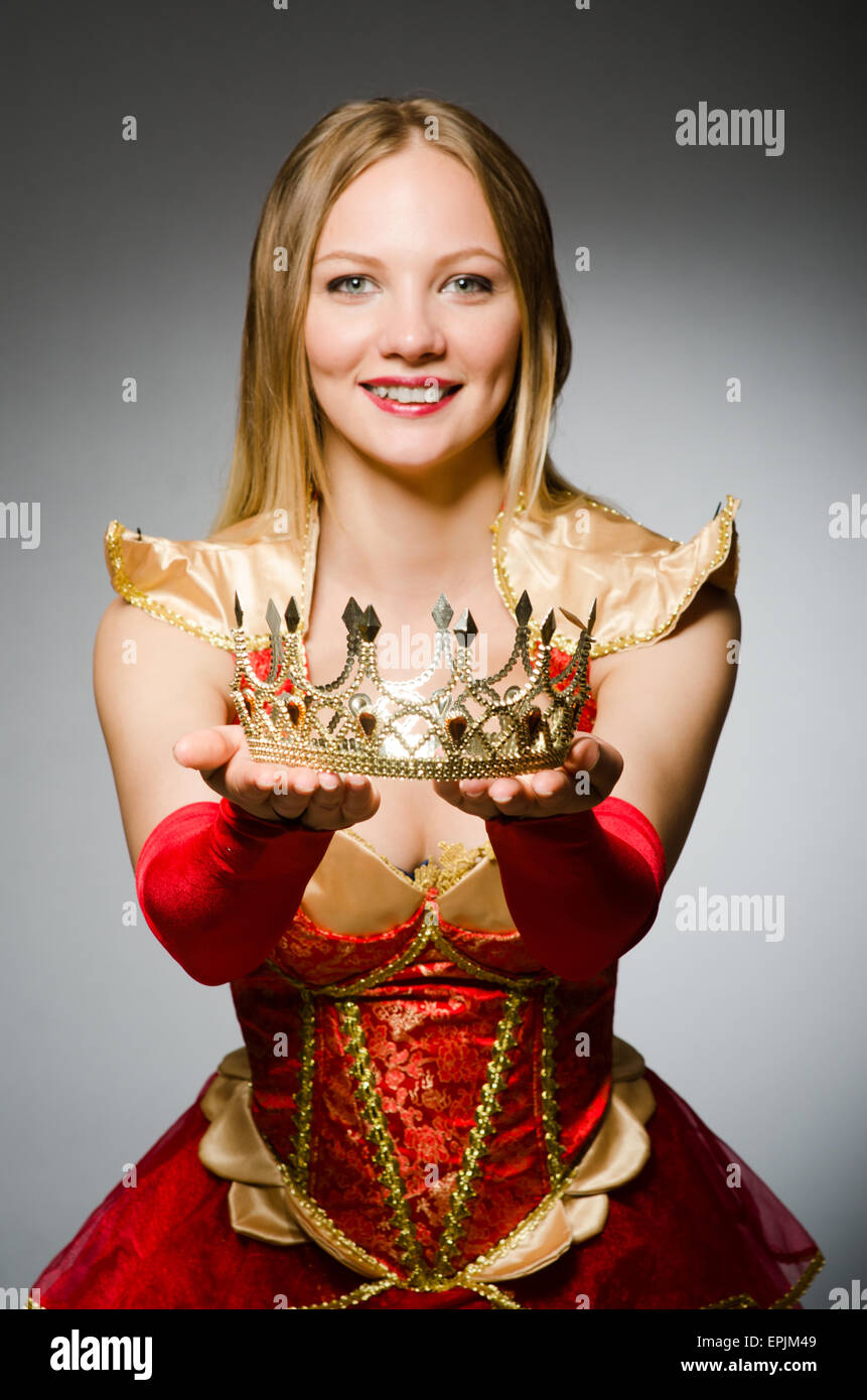 Queen in red costume against dark background Stock Photo - Alamy