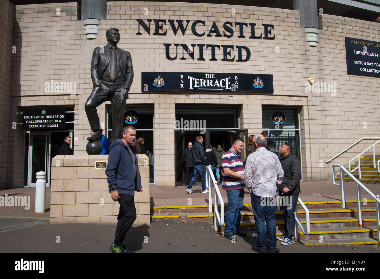 Supporters gathering underneath a statue to former manager Sir Bobby Robson, situated outside the Milburn Stand of the stadium before Newcastle United host Tottenham Hotspurs in an English Premier League match at St. James' Park. The match was boycotted by a section of the home support critical of the role of owner Mike Ashley and sponsorship by a payday loan company. The match was won by Spurs by 3-1, watched by 47,427, the lowest league gate of the season at the stadium. Stock Photo