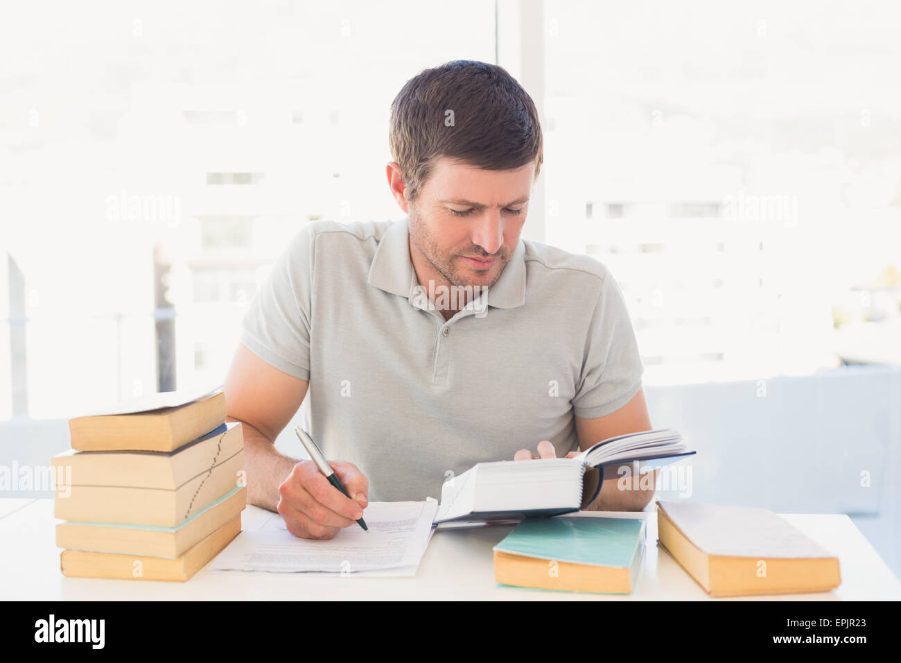 Casual businessman studying at his desk Stock Photo - Alamy