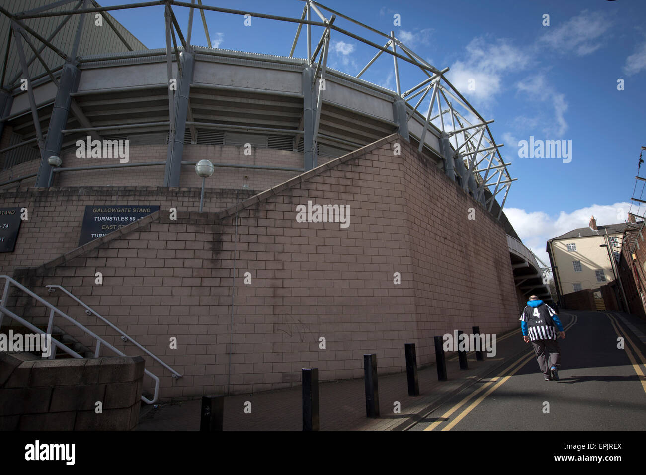 A supporter walking by the Gallowgate end of the stadium before Newcastle United host Tottenham Hotspurs in an English Premier League match at St. James' Park. The match was boycotted by a section of the home support critical of the role of owner Mike Ashley and sponsorship by a payday loan company. The match was won by Spurs by 3-1, watched by 47,427, the lowest league gate of the season at the stadium. Stock Photo