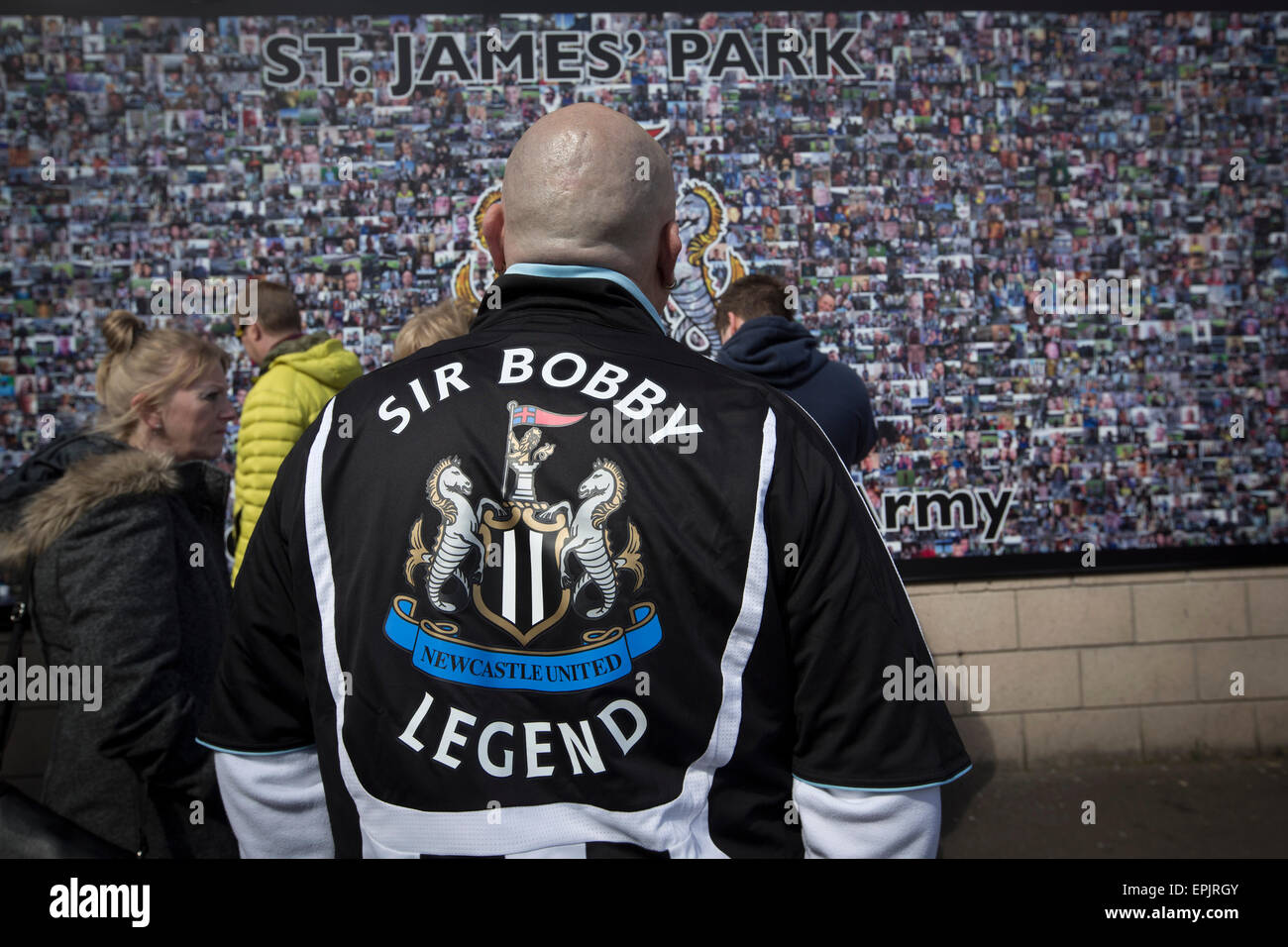 Supporters gathering by a montage of photos on a wall at the Gallowgate end of the stadium before Newcastle United host Tottenham Hotspurs in an English Premier League match at St. James' Park. The match was boycotted by a section of the home support critical of the role of owner Mike Ashley and sponsorship by a payday loan company. The match was won by Spurs by 3-1, watched by 47,427, the lowest league gate of the season at the stadium. Stock Photo