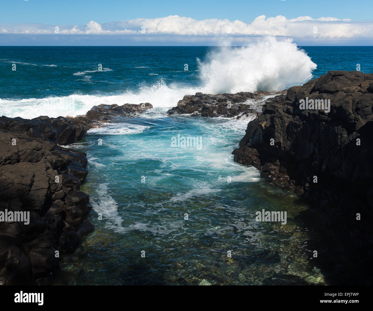 Waves hit rocks at Queens Bath Kauai Stock Photo Alamy