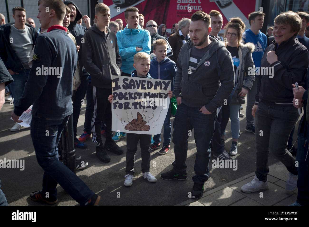 A young protester holding a sign during a demonstration at the Gallowgate end of the stadium before Newcastle United host Tottenham Hotspurs in an English Premier League match at St. James' Park. The match was boycotted by a section of the home support critical of the role of owner Mike Ashley and sponsorship by a payday loan company. The match was won by Spurs by 3-1, watched by 47,427, the lowest league gate of the season at the stadium. Stock Photo