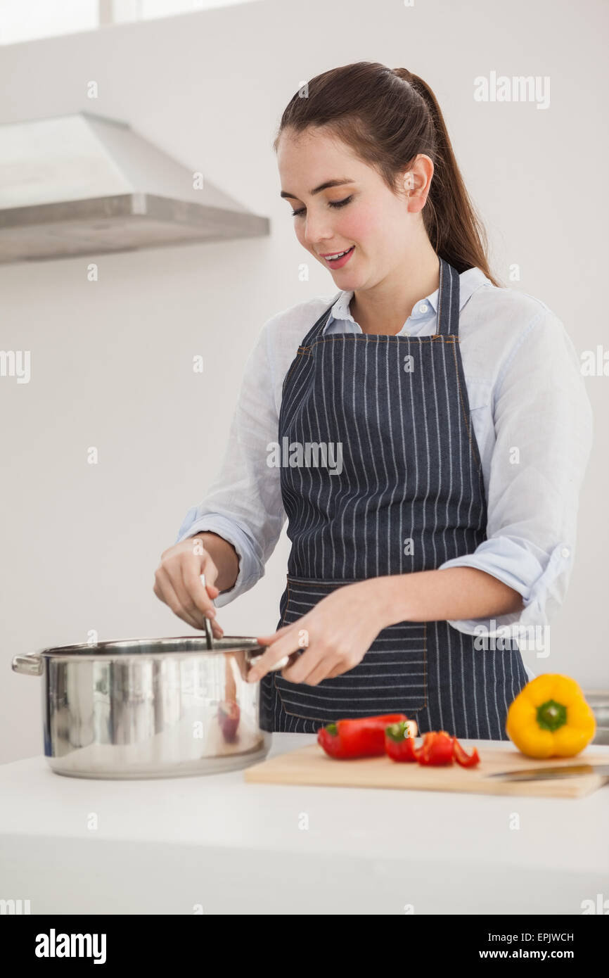 Pretty brunette cooking a healthy meal Stock Photo - Alamy