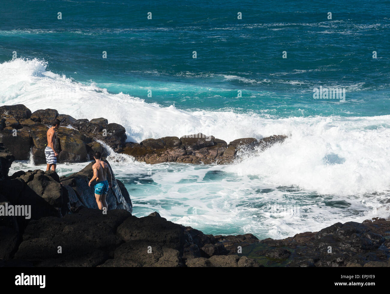 Two swimmers at Queens Bath Kauai Stock Photo