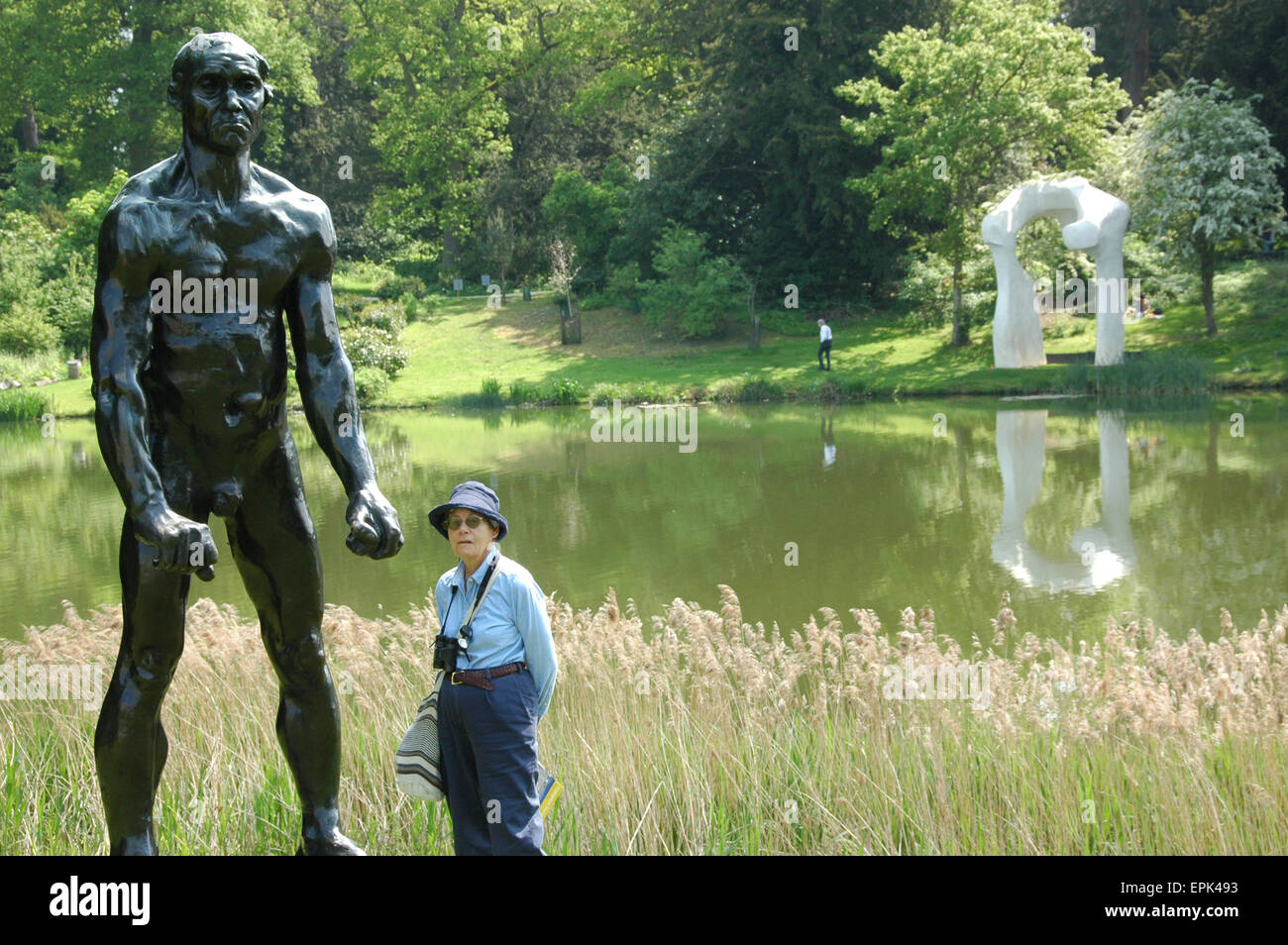 Rodin sculpture towering over tourist at Rodin and Moore Exhibition at Compton Verney, Warwickshire, England 2014 Stock Photo