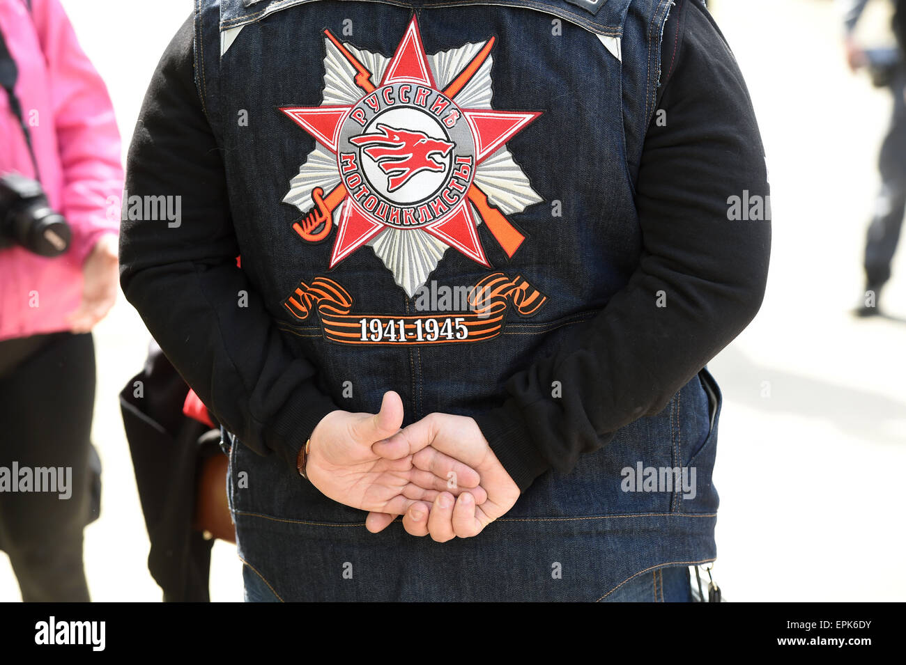 A member of the Russian motorcycle club 'Nachtwoelfe' (lit. Night wolves) wears a jacket with its logo and ribbons that consist of black and orange bicolour patterns with the writing '1941 - 1945' on it - the duration of the war with Hitler Germany - in the German-Russian Museum in Berlin, Germany, 08 May 2015. The museum is the historical place of the German Instrument of Surrender on 08 May 1945 in Berlin-Karlshorst. The Russian group started the tour on the occasion of the 70th anniversary of the End of World War II in Moscow on 25 April and arrives in Berlin on 09 May - when Russia observe Stock Photo