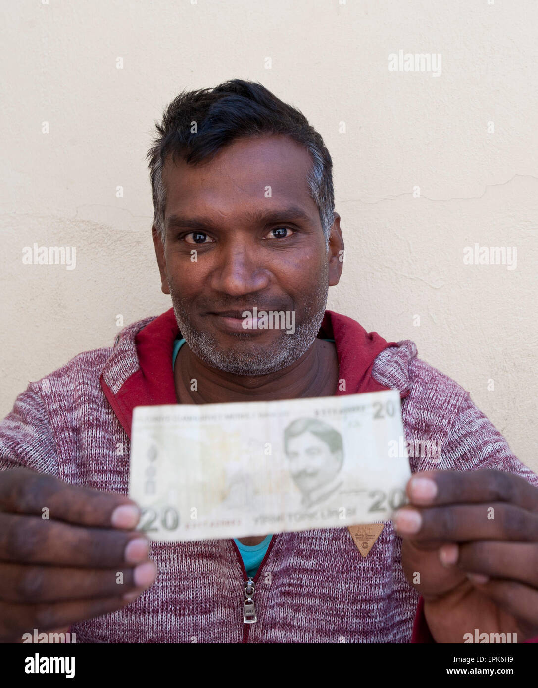 (150519) -- CHIOS, May 19, 2015 (Xinhua) -- An immigrant from Pakistan via Turkey shows a piece of Turkish money in front of the Chios police station, Chios, Greece, May 11, 2015. Chios is a short sea passage to the European Union, opposite Turkey, 8 km in a straight line. It is one of the islands which have seen traffic increase exponentially, with more than 6,000 immigrants rescued at sea last year and more than 5,000 in the first months of 2015 up to early May, according to the island Police. For over two years now, ever since the fence at the Greek-Turkish border of Evros was constructed,  Stock Photo