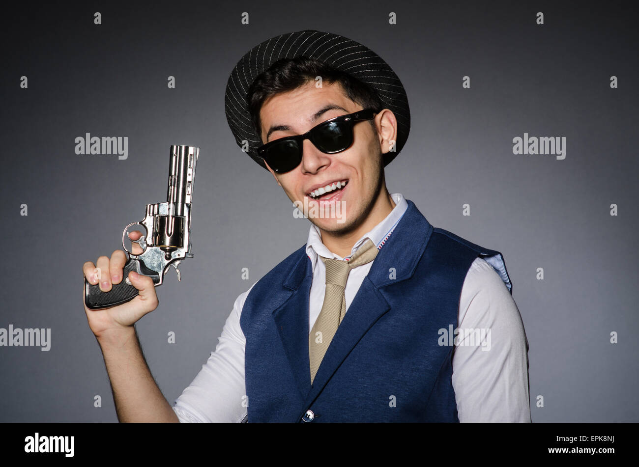 Man wearing sunglasses with gun Stock Photo Alamy