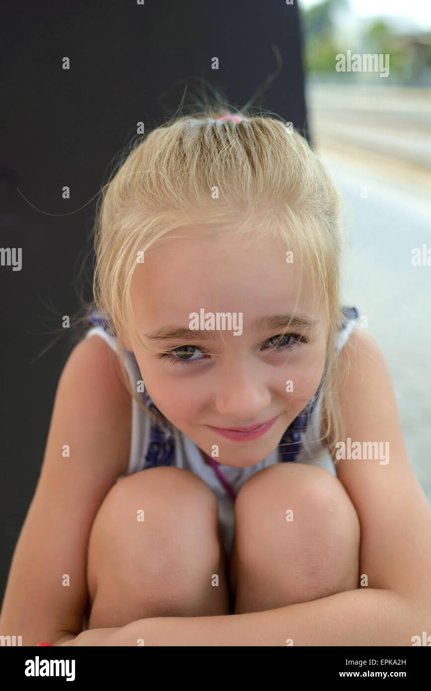 Child hugging knees hi-res stock photography and images - Alamy