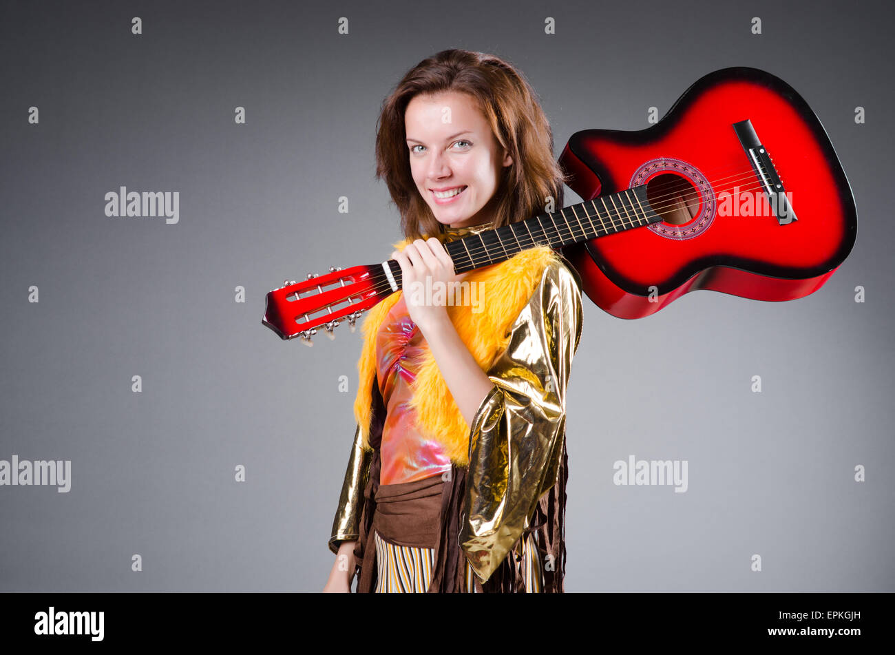 Guitar player with red instrument Stock Photo - Alamy