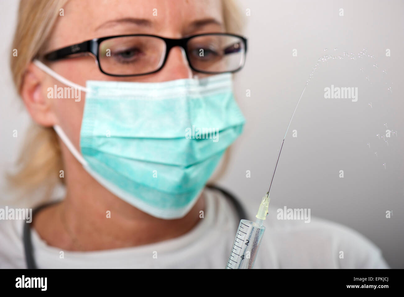 Female doctor testing injection Stock Photo
