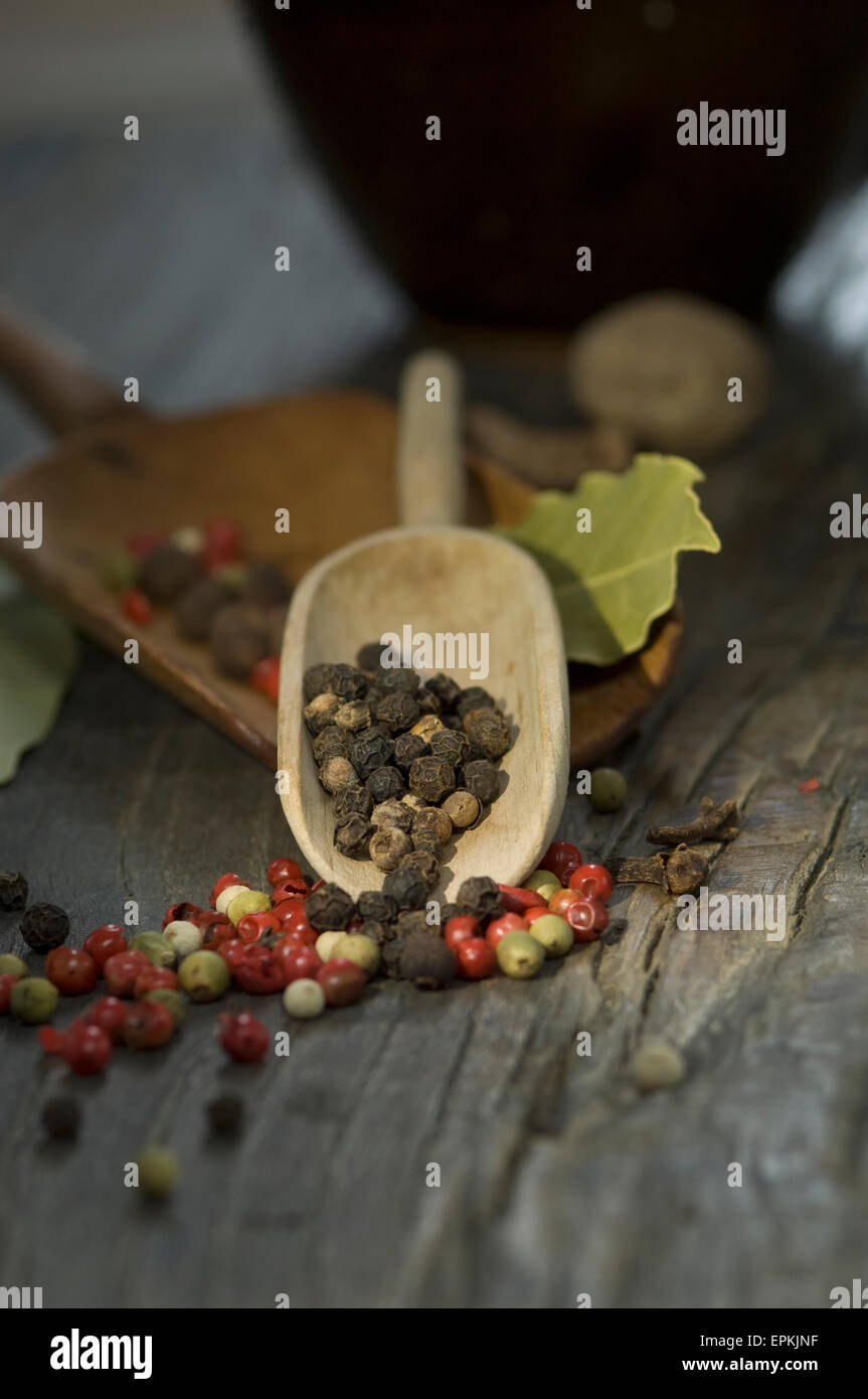 Wooden shovels and different spices on wood Stock Photo