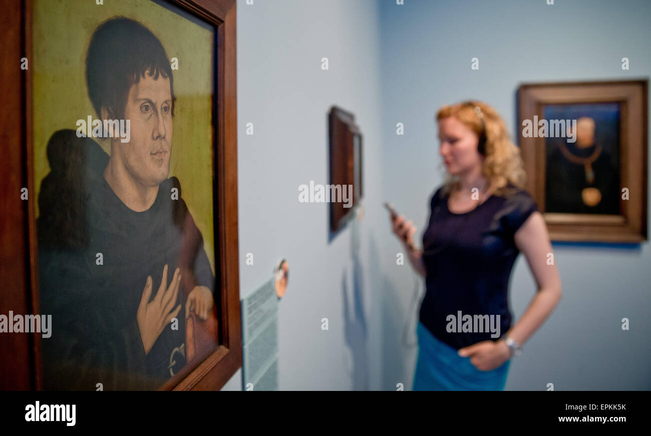 A Woman Holds A Specially Made Audio Guide In Her Hand As She Stands 