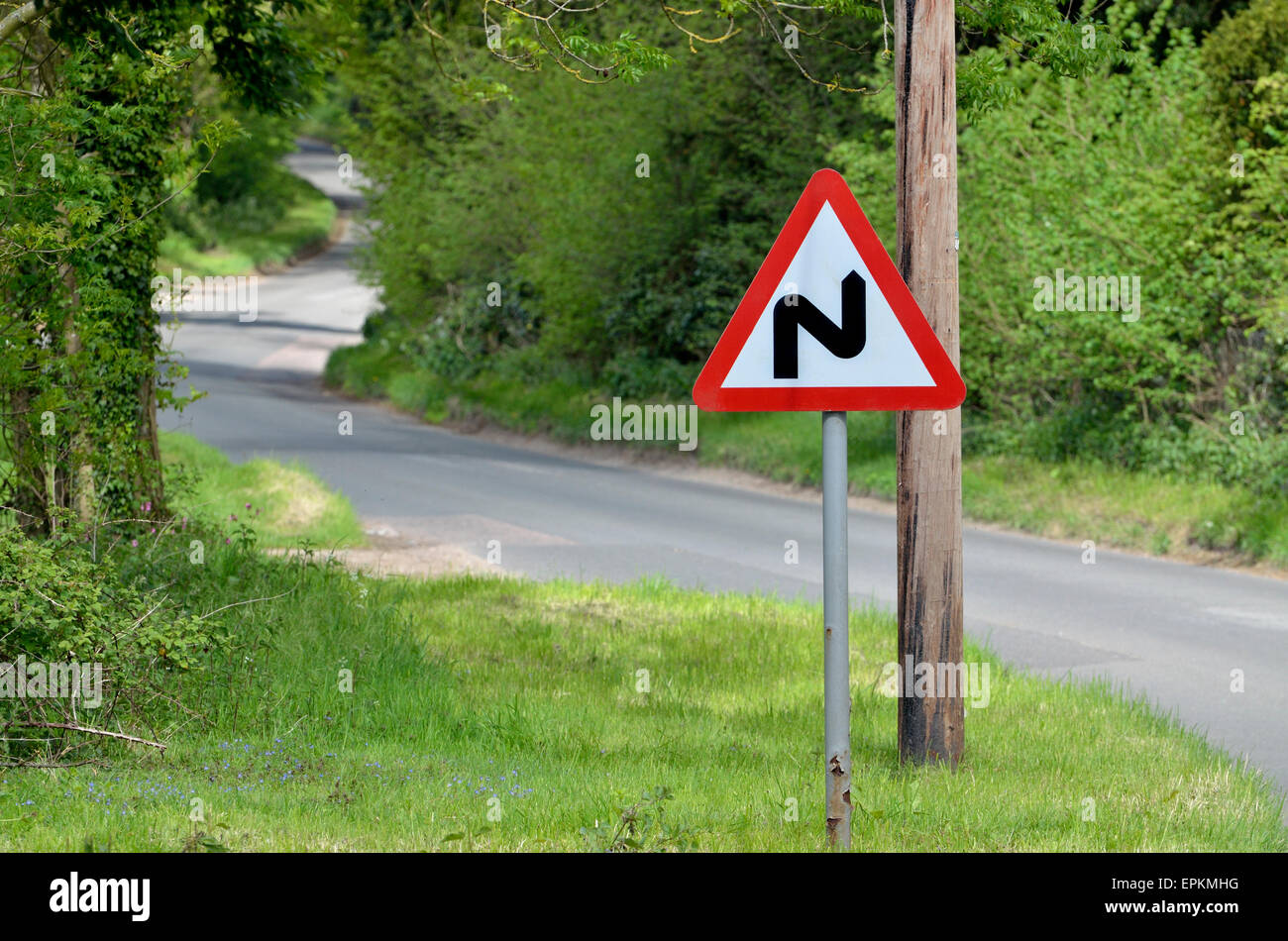 'Double Bend' warning road sign on a narrow country road in Norfolk, England. Stock Photo