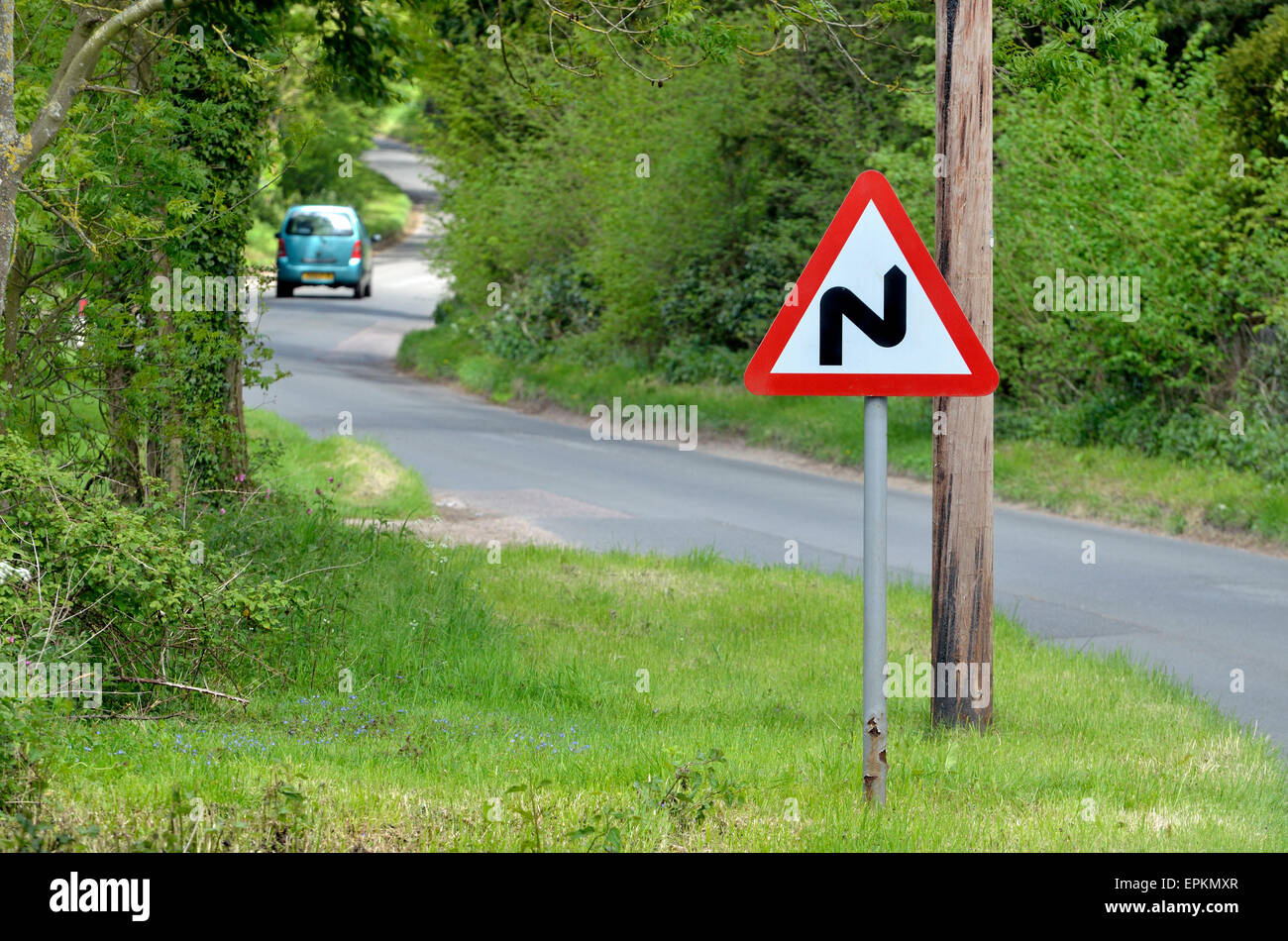 'Double Bend' warning roadsign on a narrow country road in Norfolk, England. Stock Photo