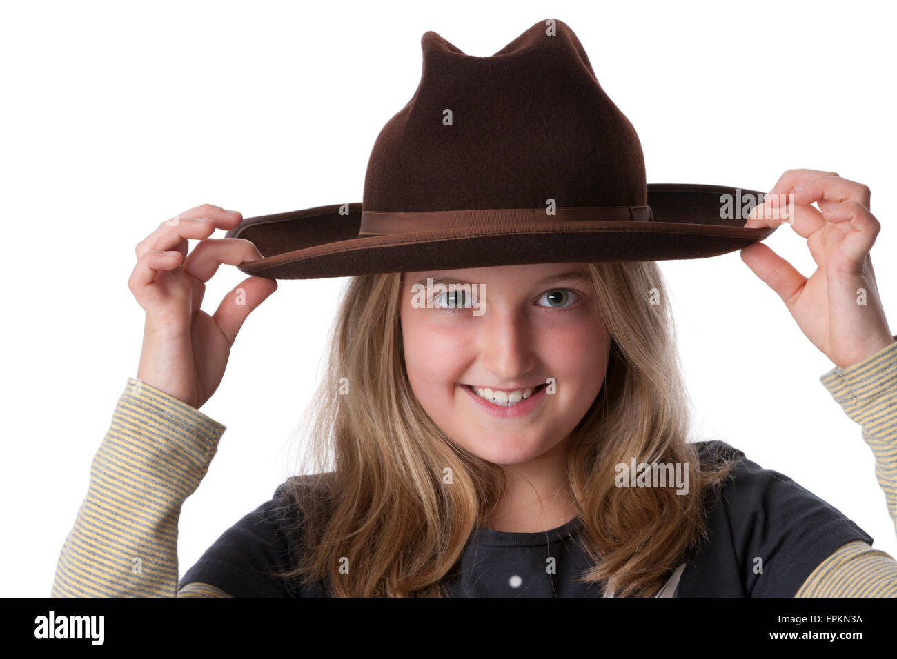 Portrait of a eight year old happy blond girl with old brown hat on