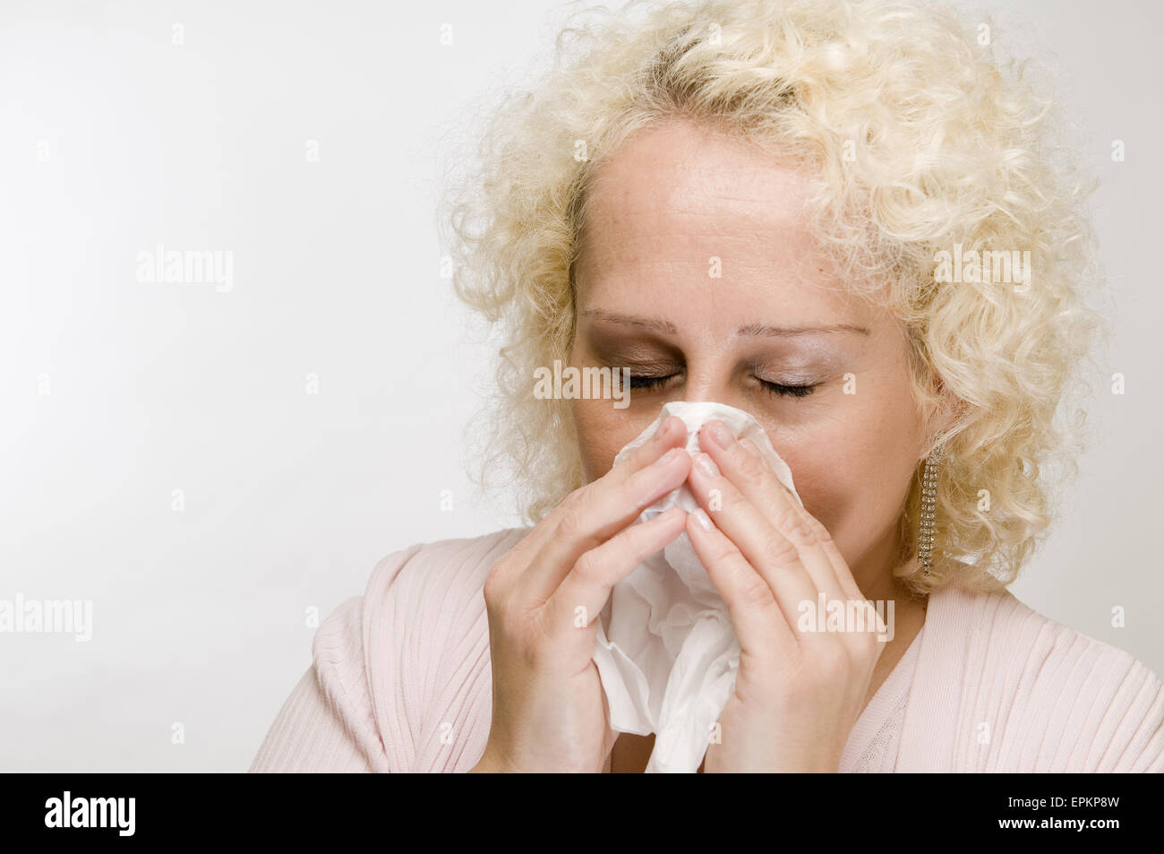 sniff in a handkerchief closes eyes Stock Photo