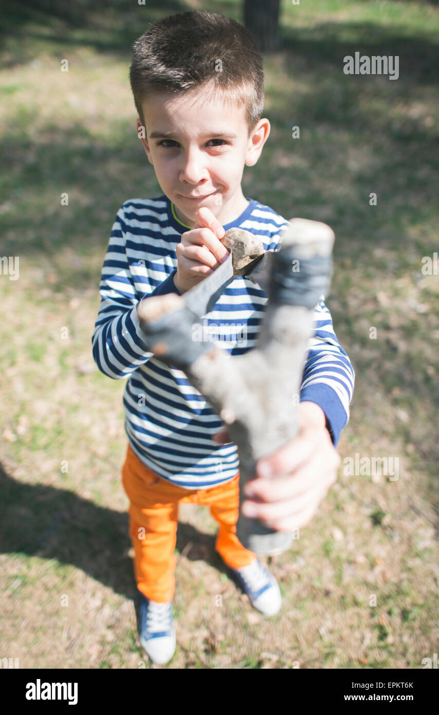 Portrait of boy with slingshot Stock Photo Alamy