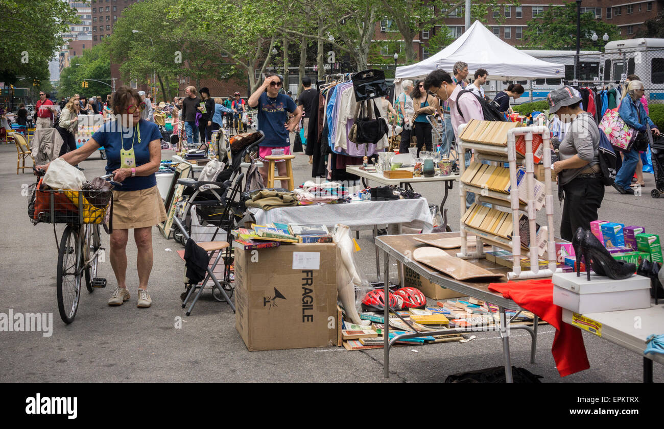 Shoppers search for bargains at the humongous Penn South Flea Market in the New York neighborhood of Chelsea on Saturday, May 16, 2015. The flea market appears like Brigadoon, only once every year, and the residents of the 20 building Penn South cooperatives have a closet cleaning extravaganza. Shoppers from around the city come to the flea market which attracts thousands passing through.  (© Richard B. Levine) Stock Photo