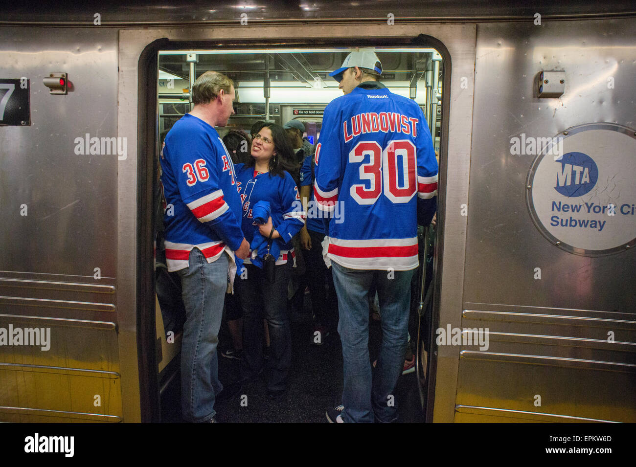 Rangers fans crowd into a subway train in New York after a playoff game on Saturday, May 16
